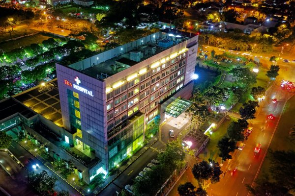 A hospital with its lights on at night